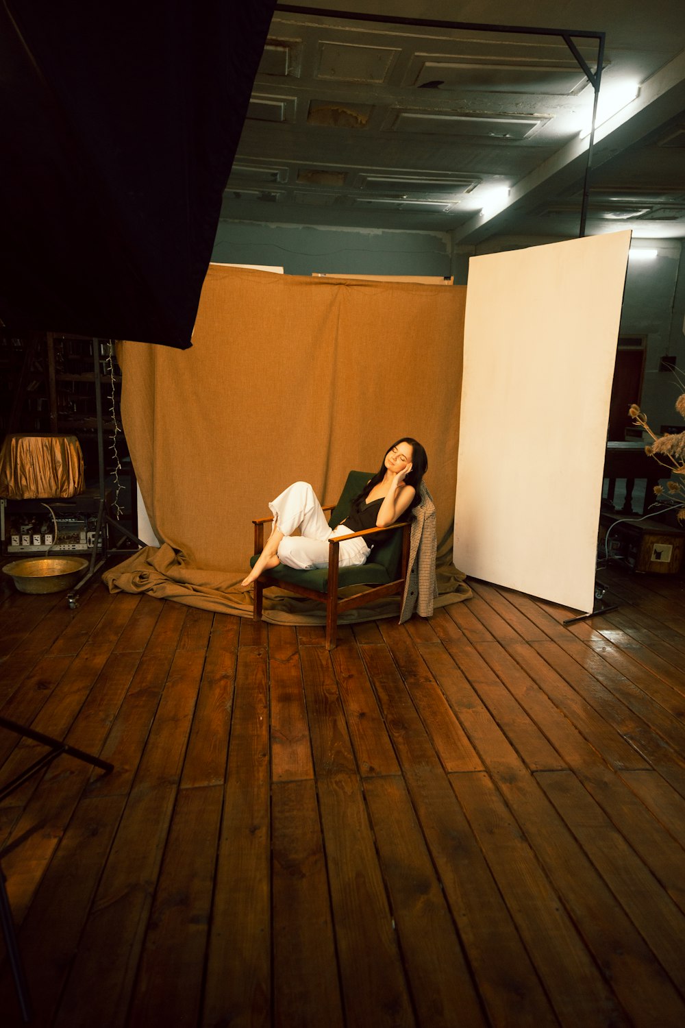 woman in white tank top sitting on black and white armchair