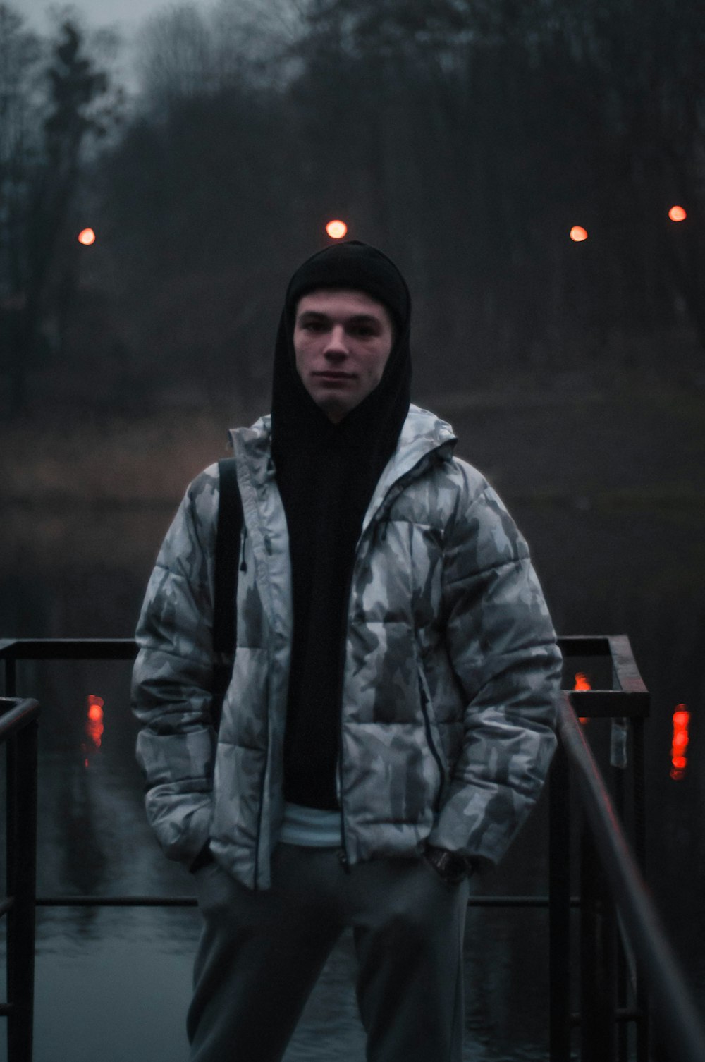 man in black knit cap and black jacket standing