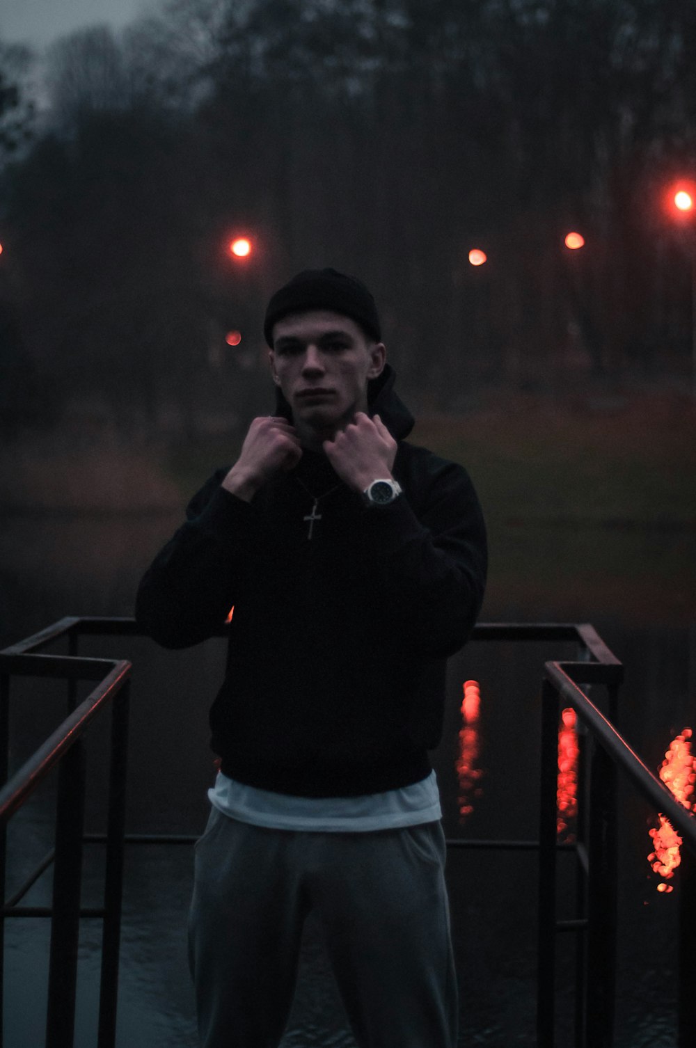 man in black long sleeve shirt and blue denim shorts