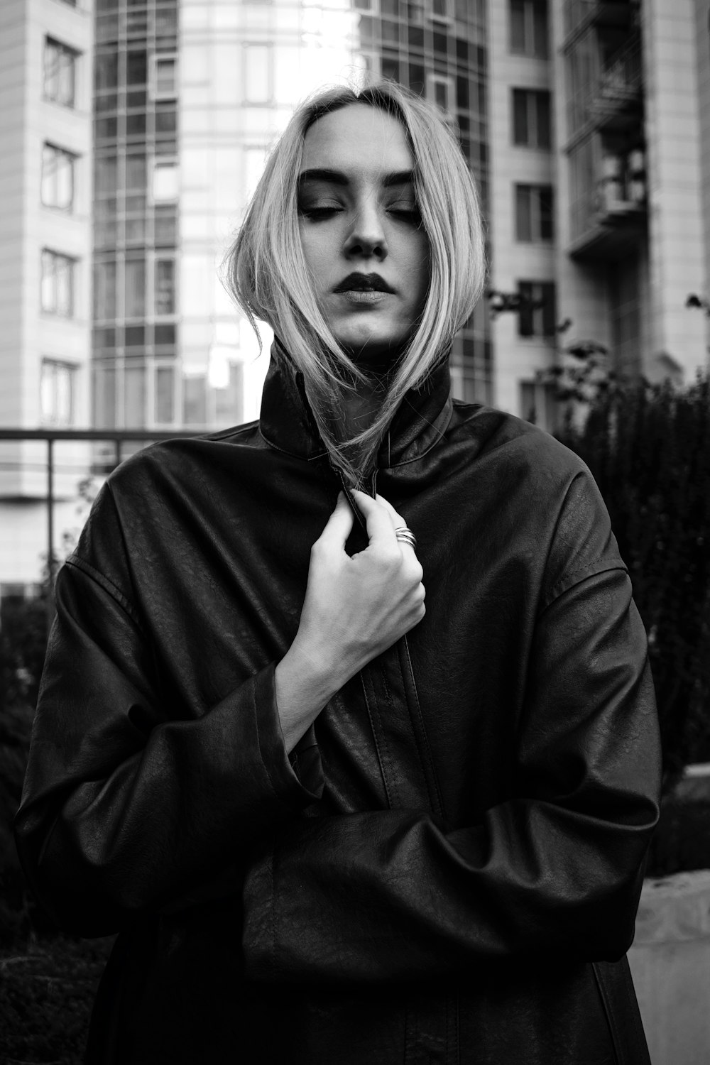 grayscale photo of woman in black coat