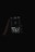 A dark, moody image showing a hand holding a smartphone with a music player app open. The screen displays a song titled 'PAID MY DUES' by NF. The background is completely black, emphasizing the illuminated screen.