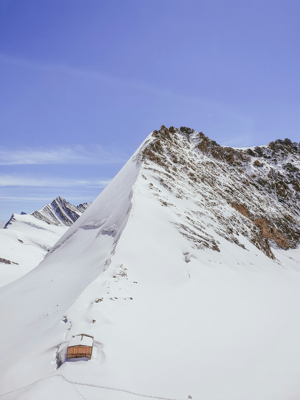 snow covered mountain under blue sky during daytime