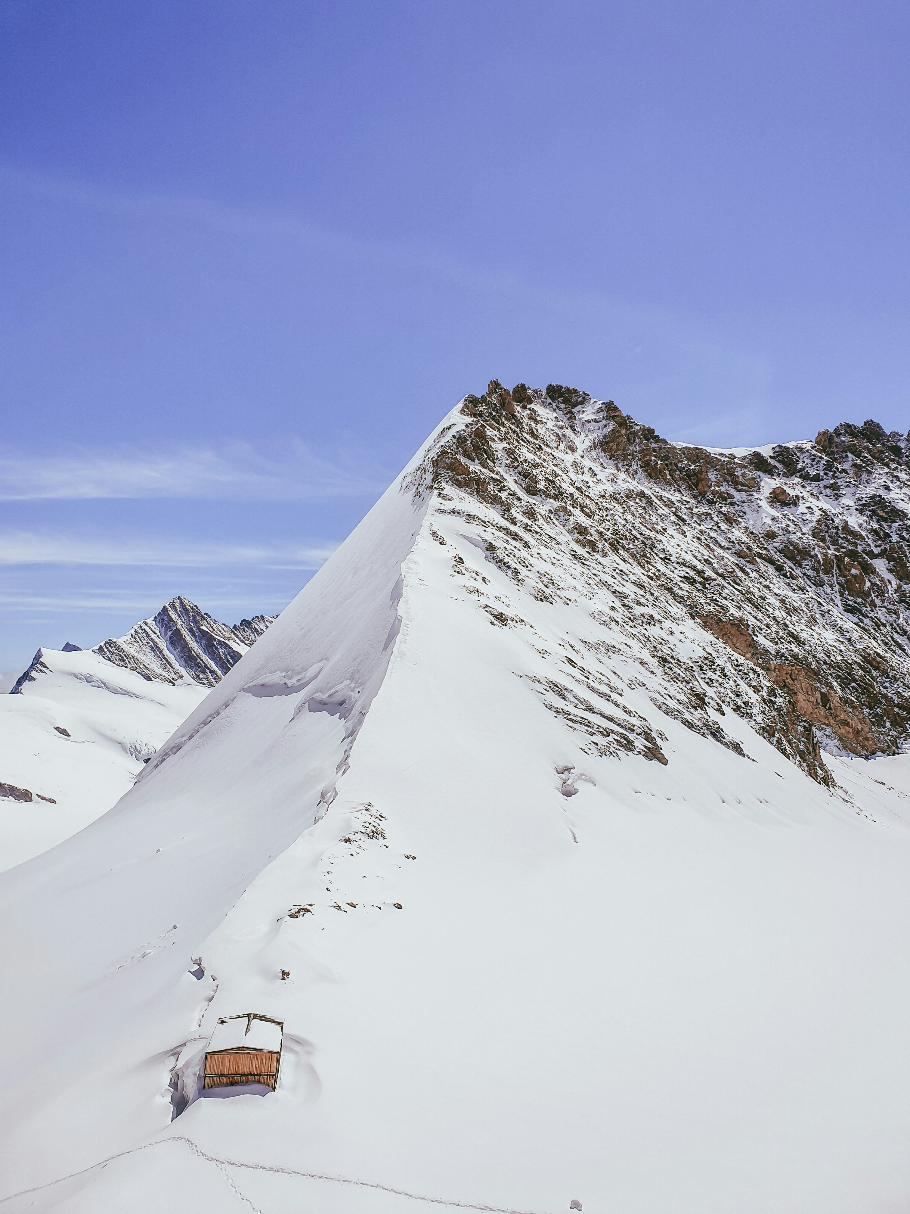 snow covered mountain under blue sky during daytime
