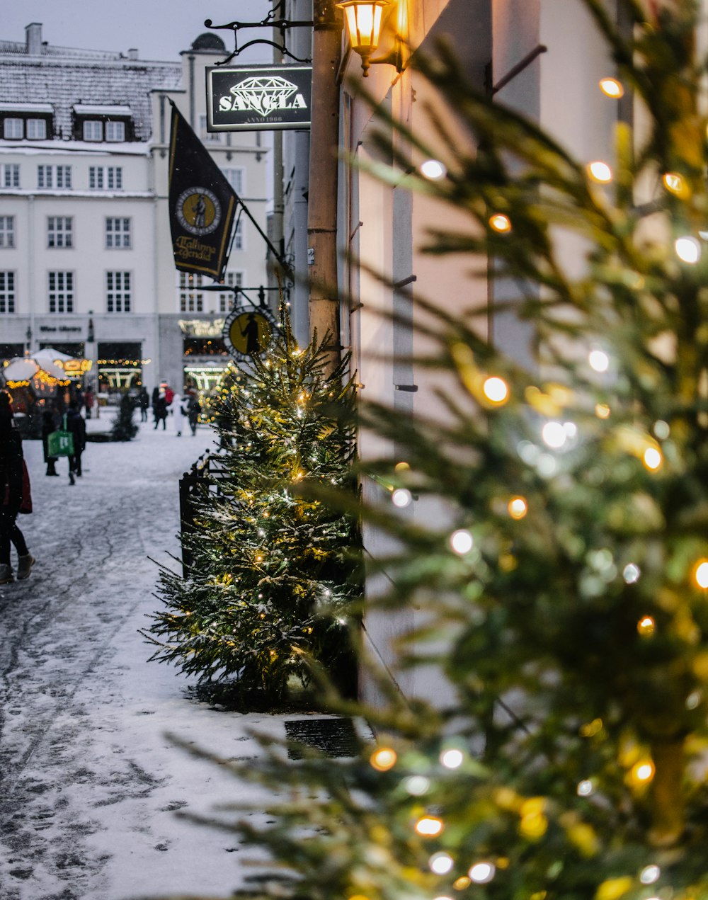 people walking on snow covered road near building during daytime