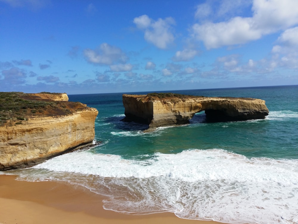 brown rock formation on sea shore during daytime