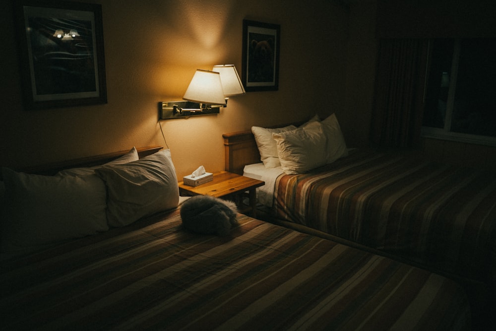 white and brown table lamp on brown wooden nightstand