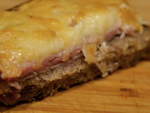 Close-up of the club house sandwich stacked high with fresh ingredients and melted cheese.