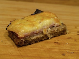A golden ham fresh out of the oven, steam rising gently, surrounded by orange slices.