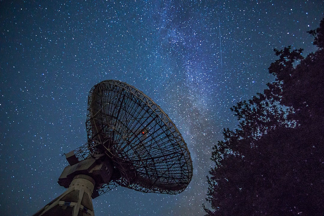 white satellite dish under blue sky during night time