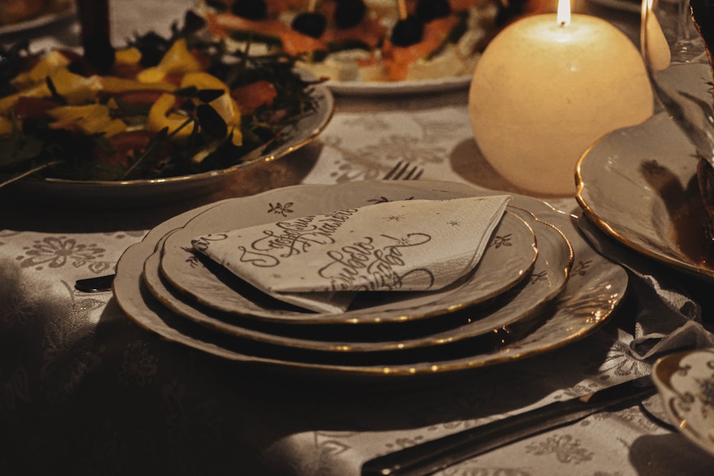 white pillar candle on silver round tray