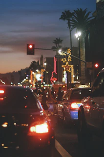 A bustling city street scene alive with colorful lights at dusk