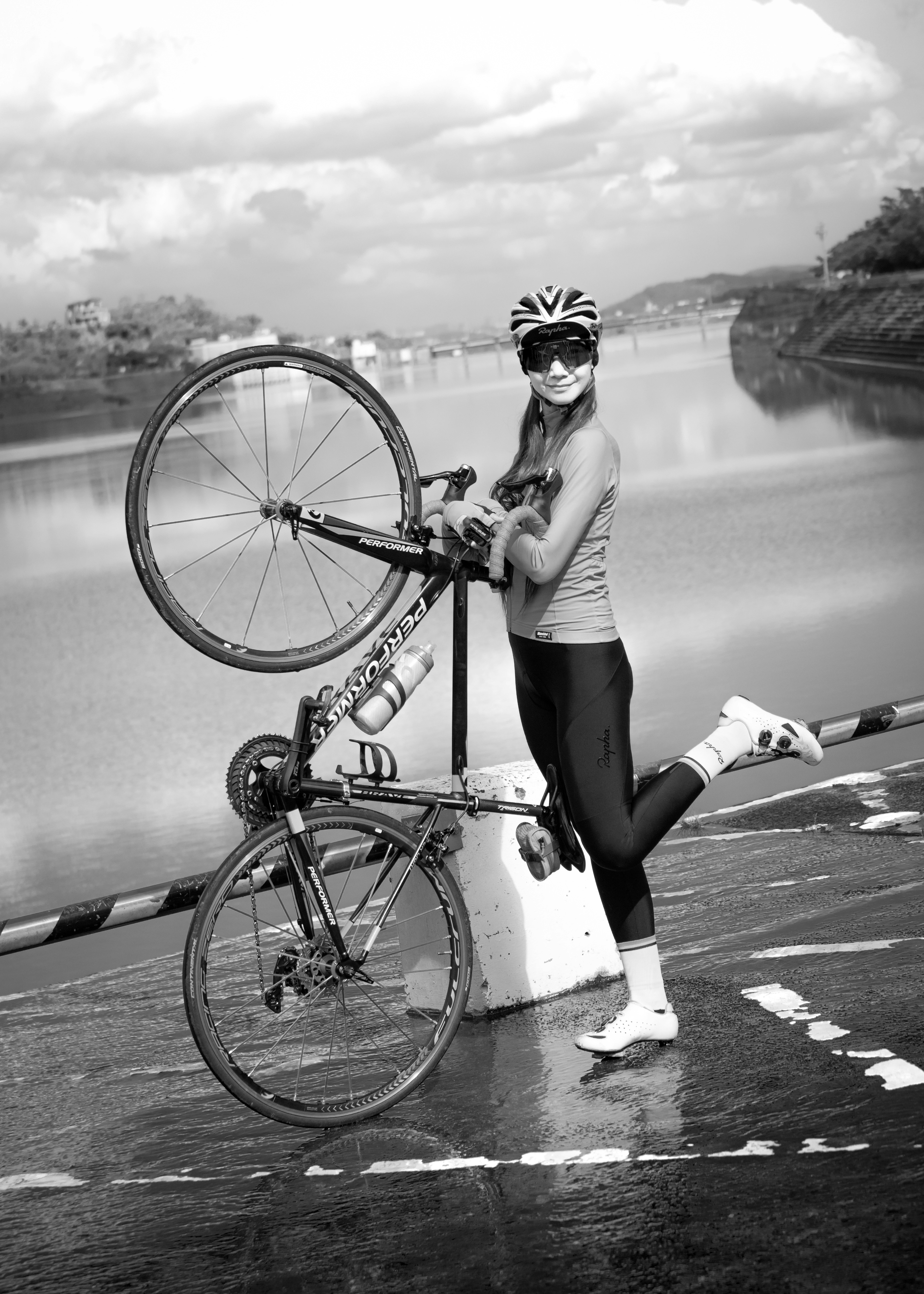 woman in tank top and black shorts riding on bicycle