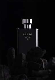 a black and white photo of a bottle of prada