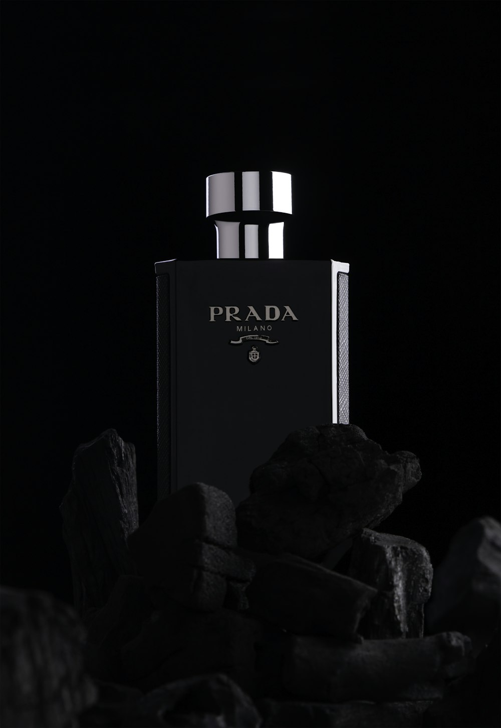 a black and white photo of a bottle of prada