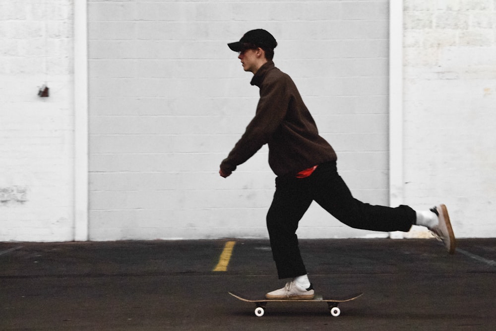 man in black pants and brown jacket riding skateboard