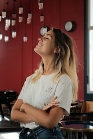 woman in white crew neck t-shirt sitting on chair