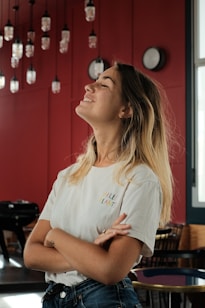 woman in white crew neck t-shirt sitting on chair
