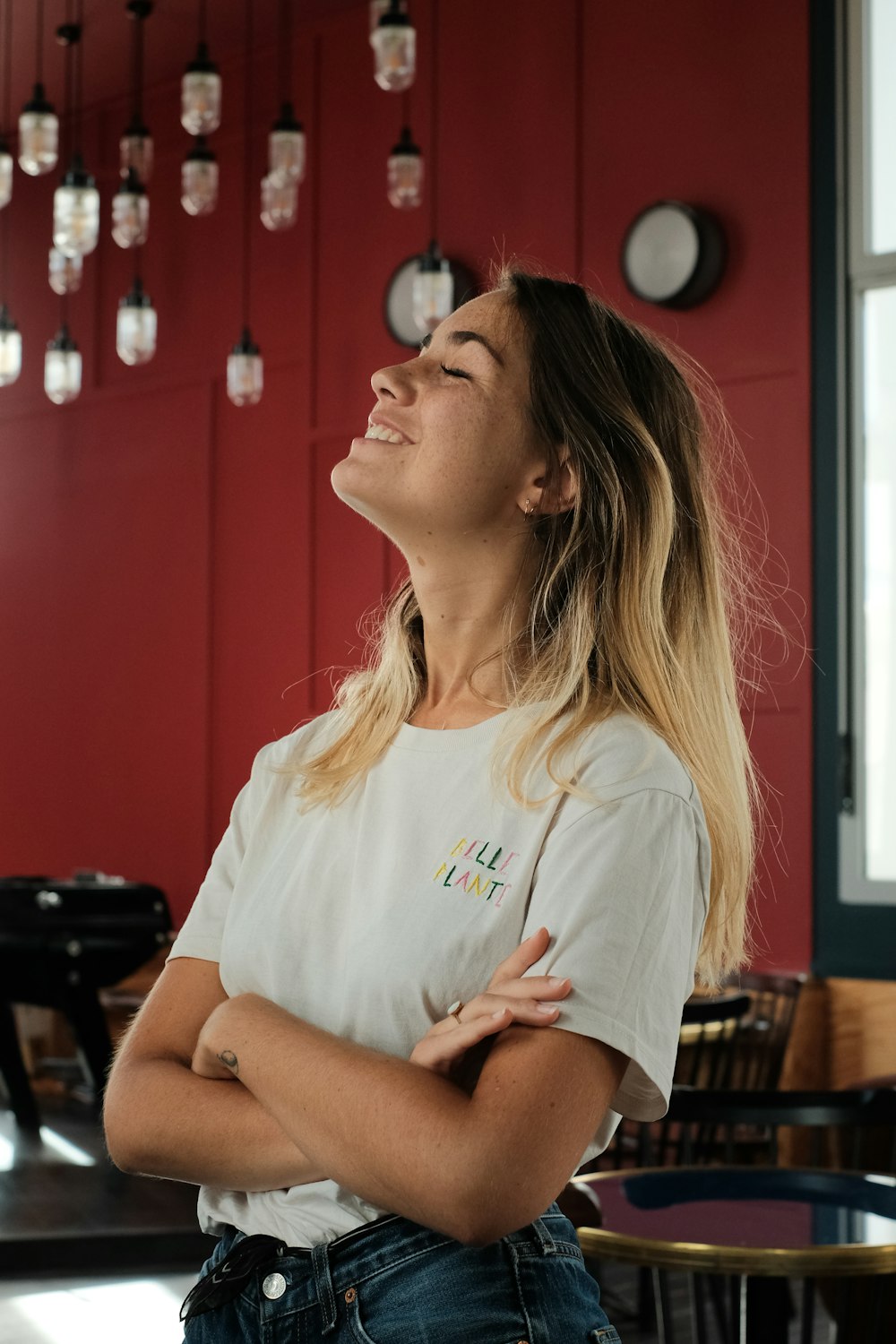 woman in white crew neck t-shirt sitting on chair