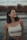 woman in white tank top standing near body of water during daytime