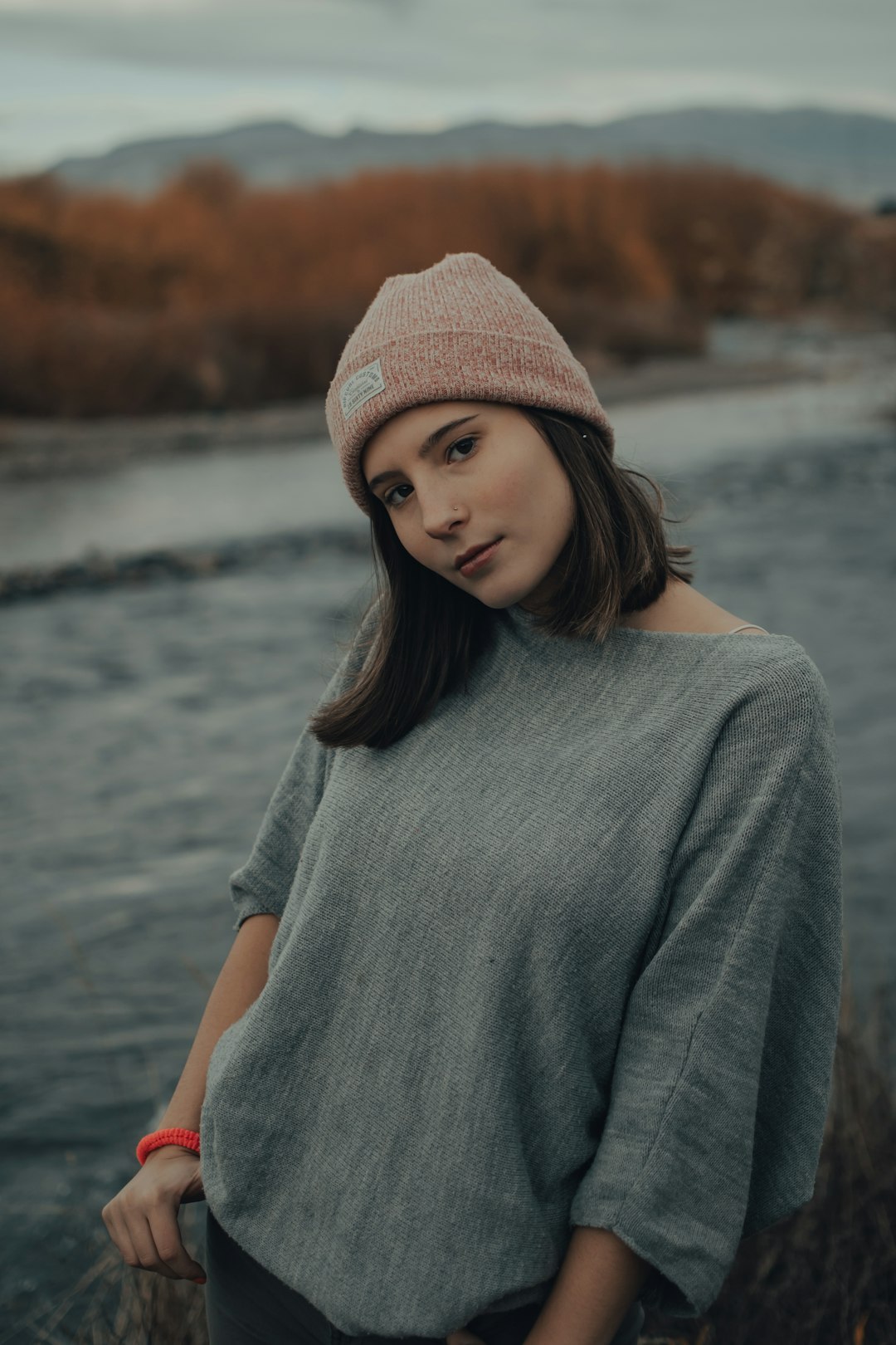 woman in gray sweater and brown knit cap