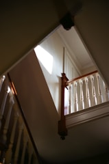 A beautifully installed hardwood staircase bathed in natural light.