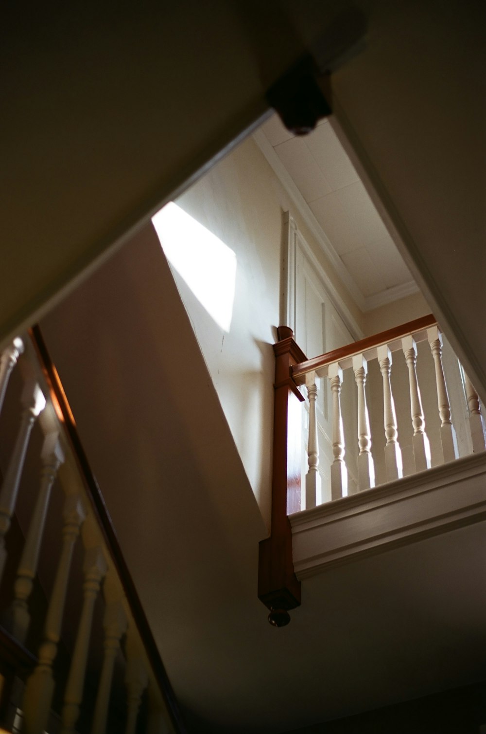 brown wooden staircase in white room