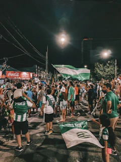 Players celebrating a goal with vibrant Cartagena streets in the background during Futbol Fest CTG.