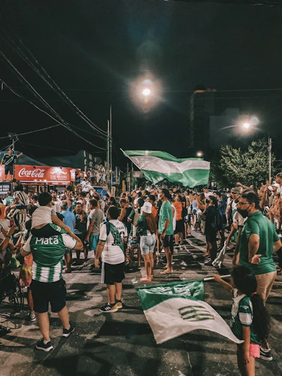 Players celebrating a goal with vibrant Cartagena streets in the background during Futbol Fest CTG.
