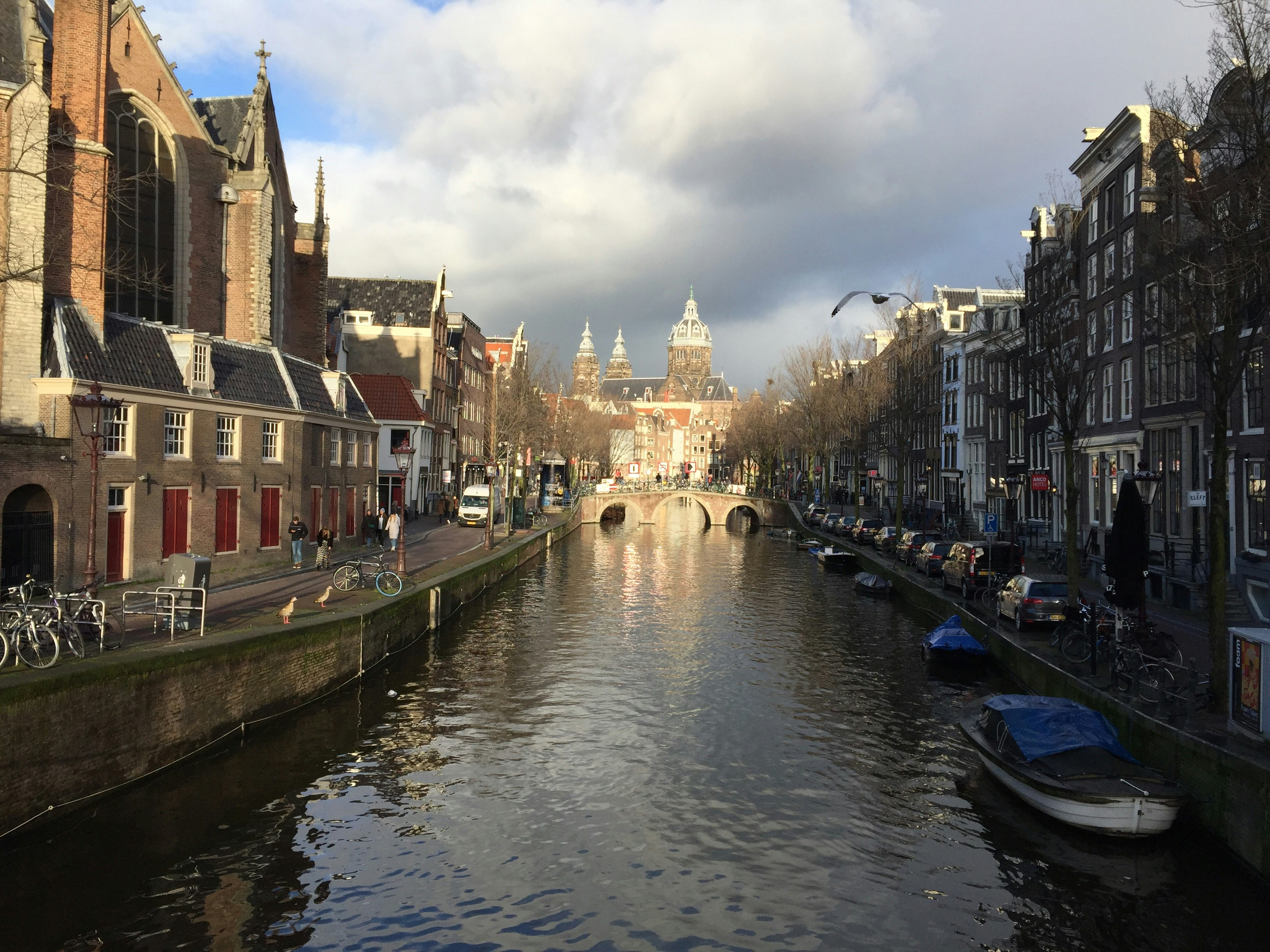 boat on river between buildings during daytime