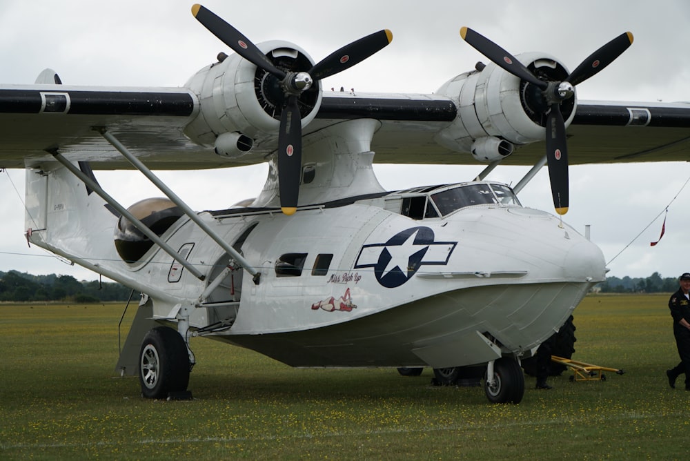 gray and black fighter plane on green grass field during daytime