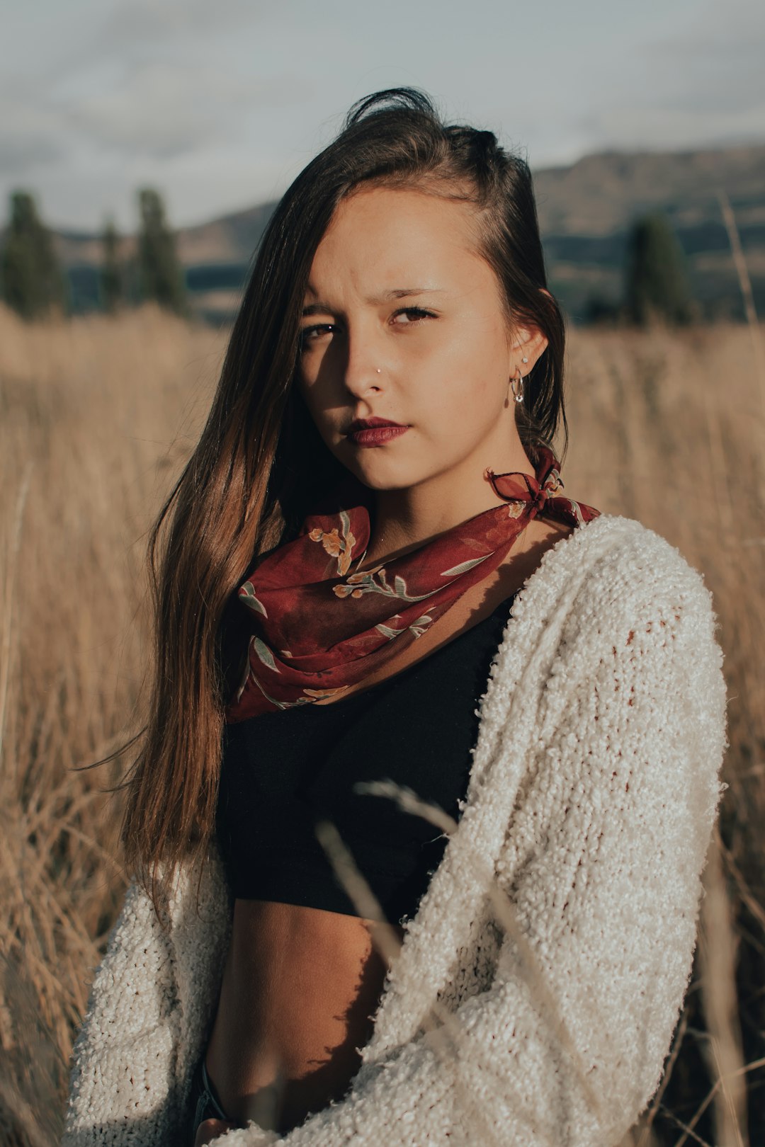 woman in white knit cardigan and black shirt