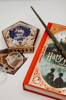 brown and black book beside eyeglasses