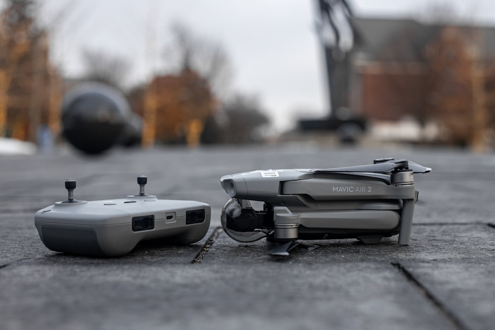 white and black drone on gray concrete floor