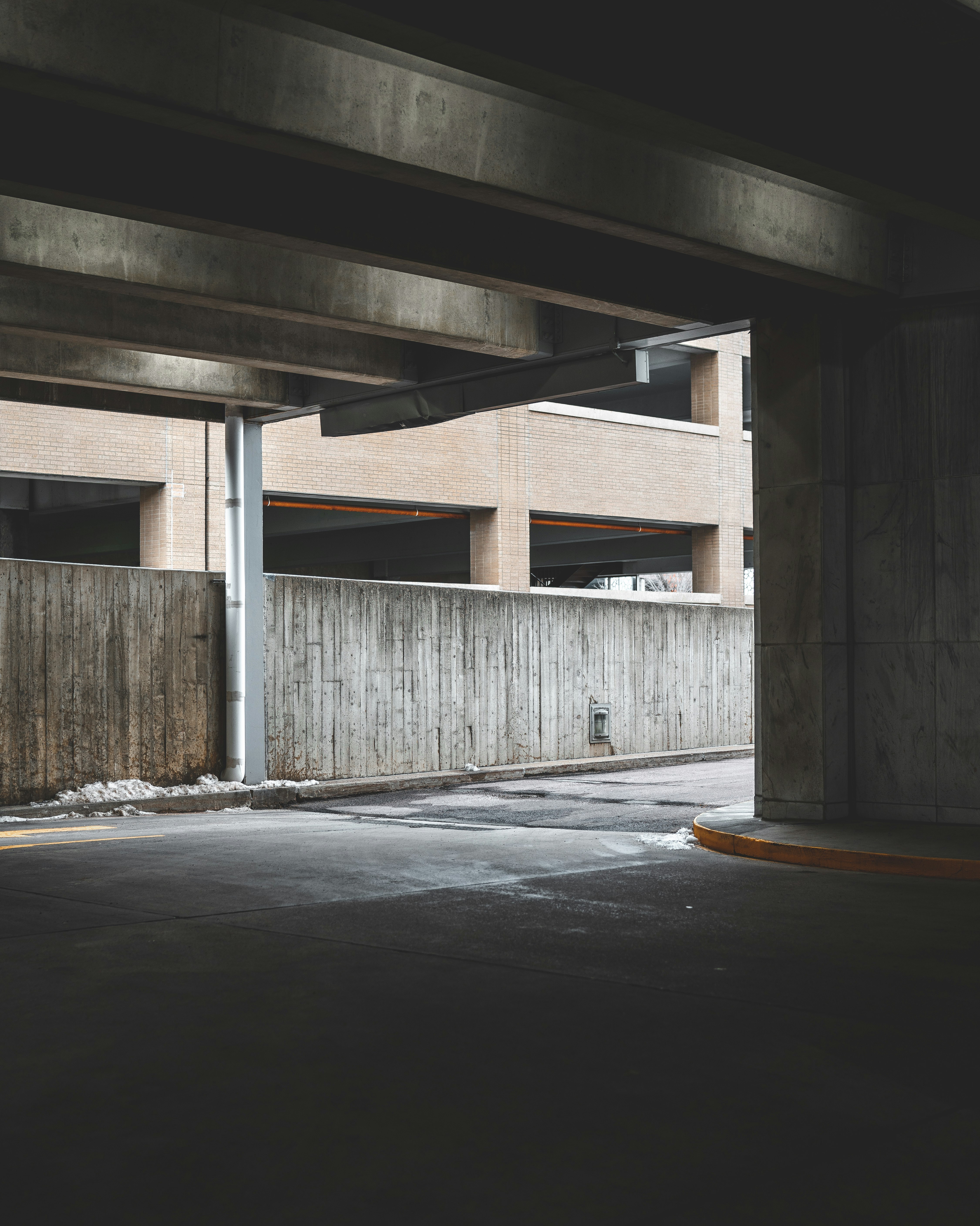 brown wooden fence near gray concrete wall