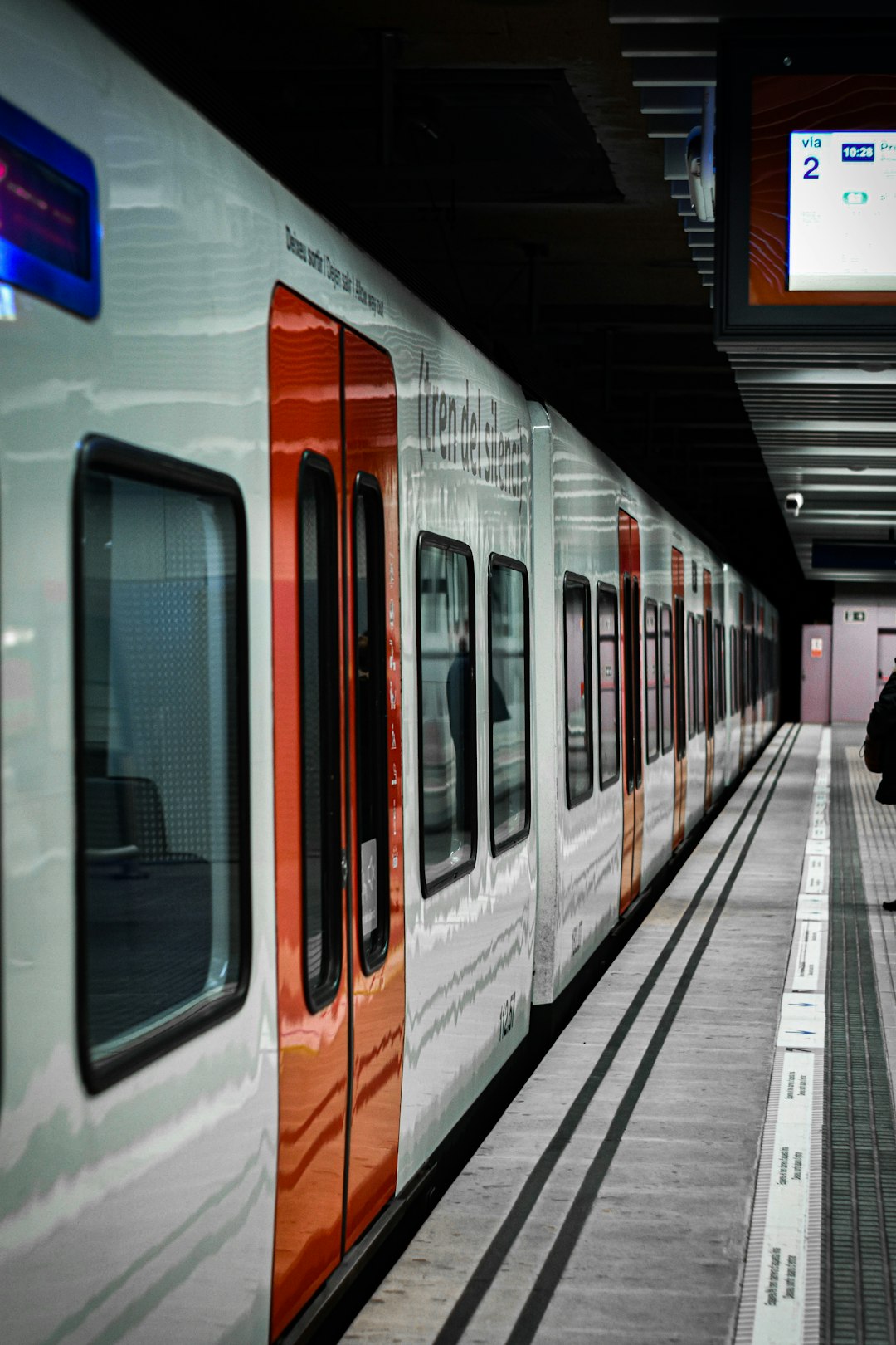 white and orange train in train station