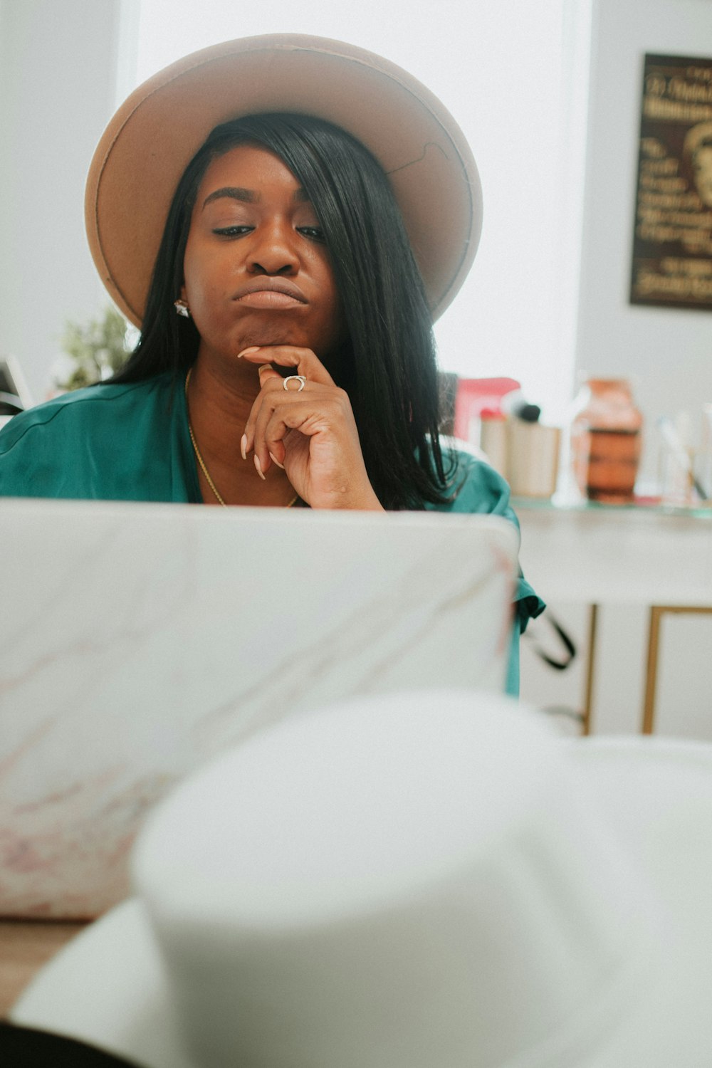 woman in green shirt wearing white hat