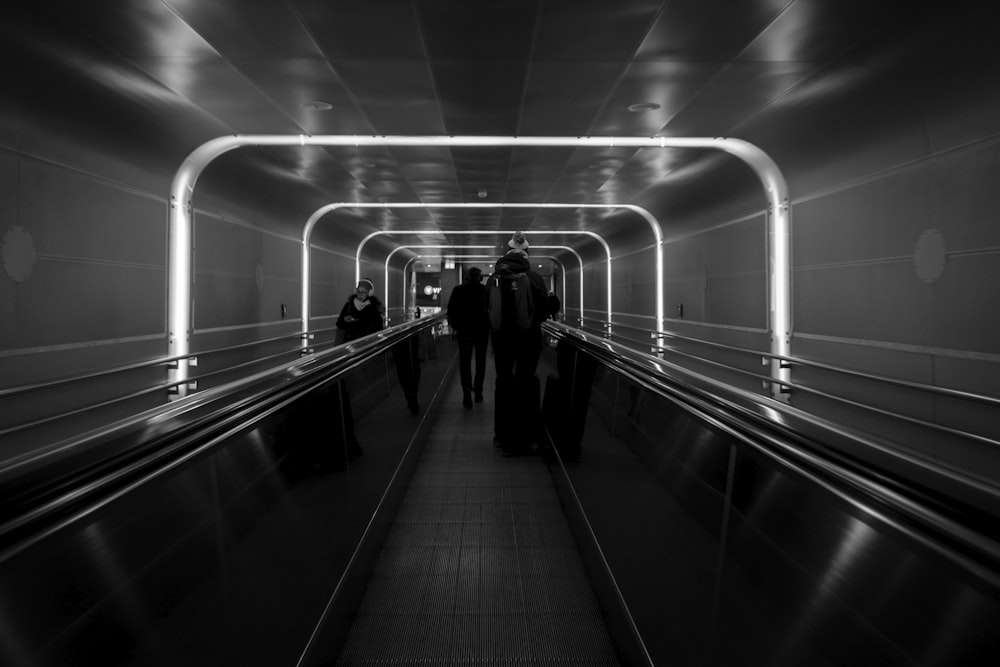 man and woman walking on the train station