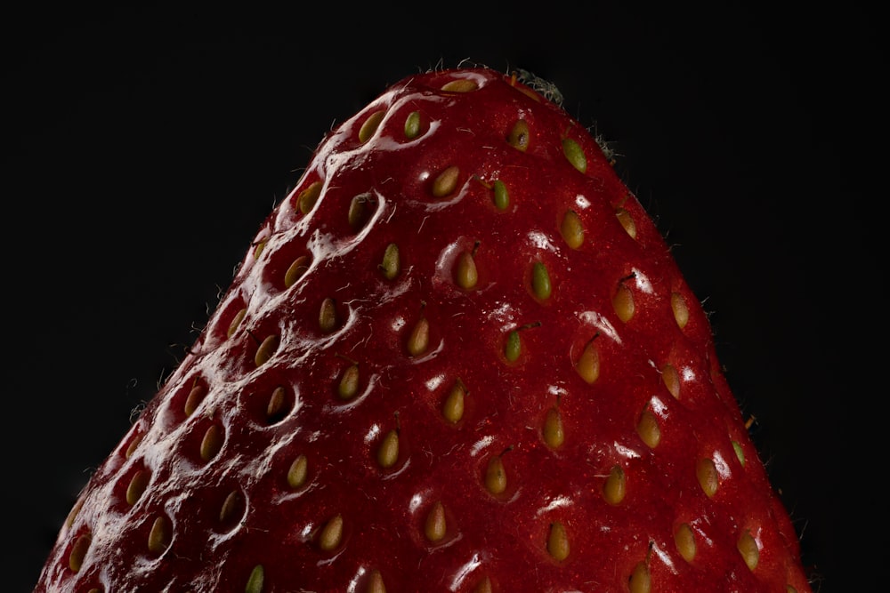red strawberry fruit on black background