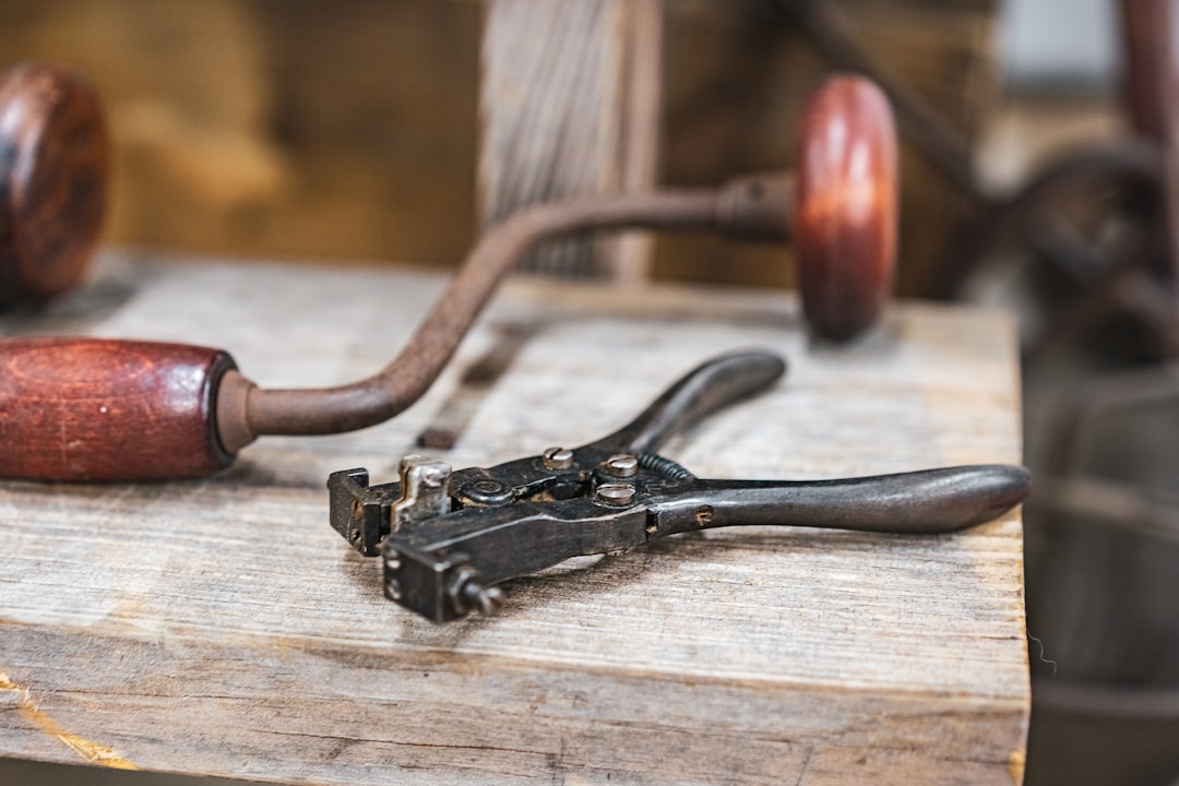 black metal tool on brown wooden table