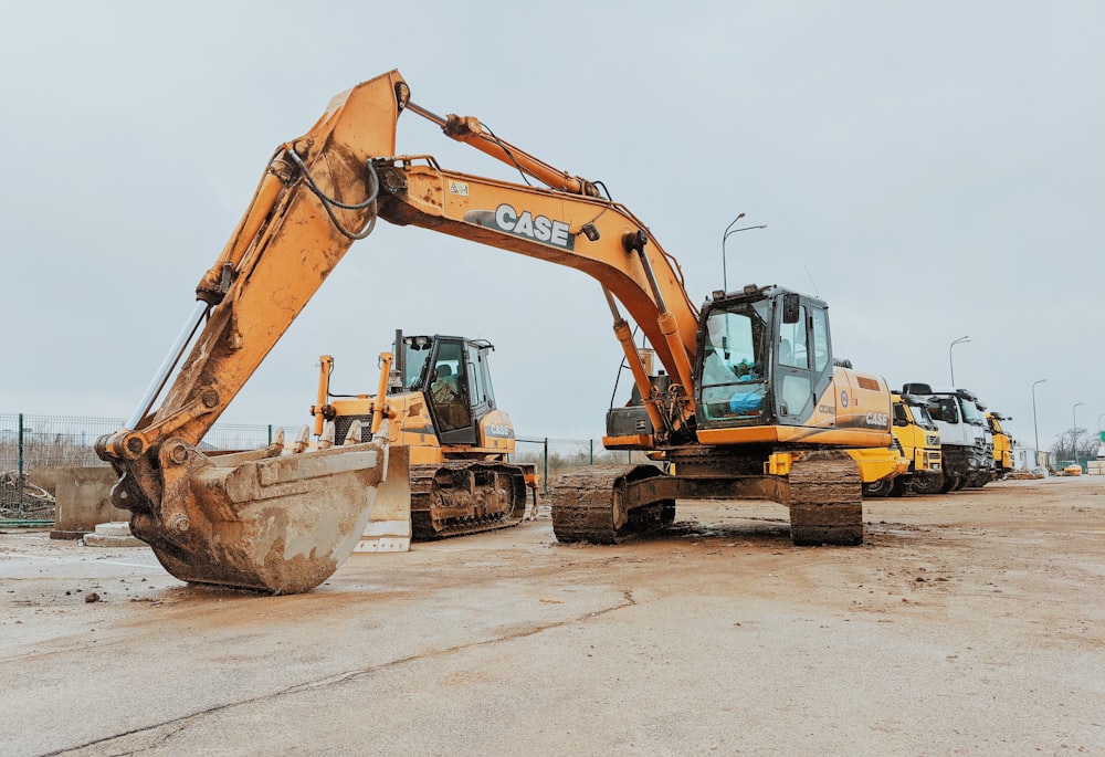 yellow excavator on gray concrete road during daytime