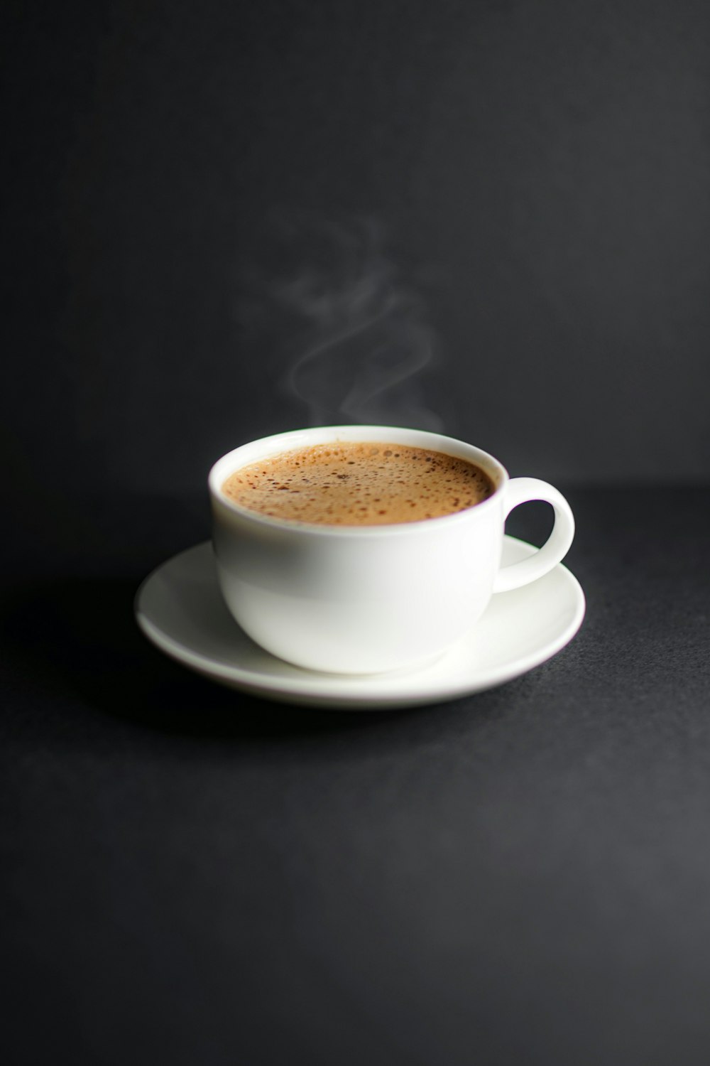 white ceramic cup on white ceramic saucer