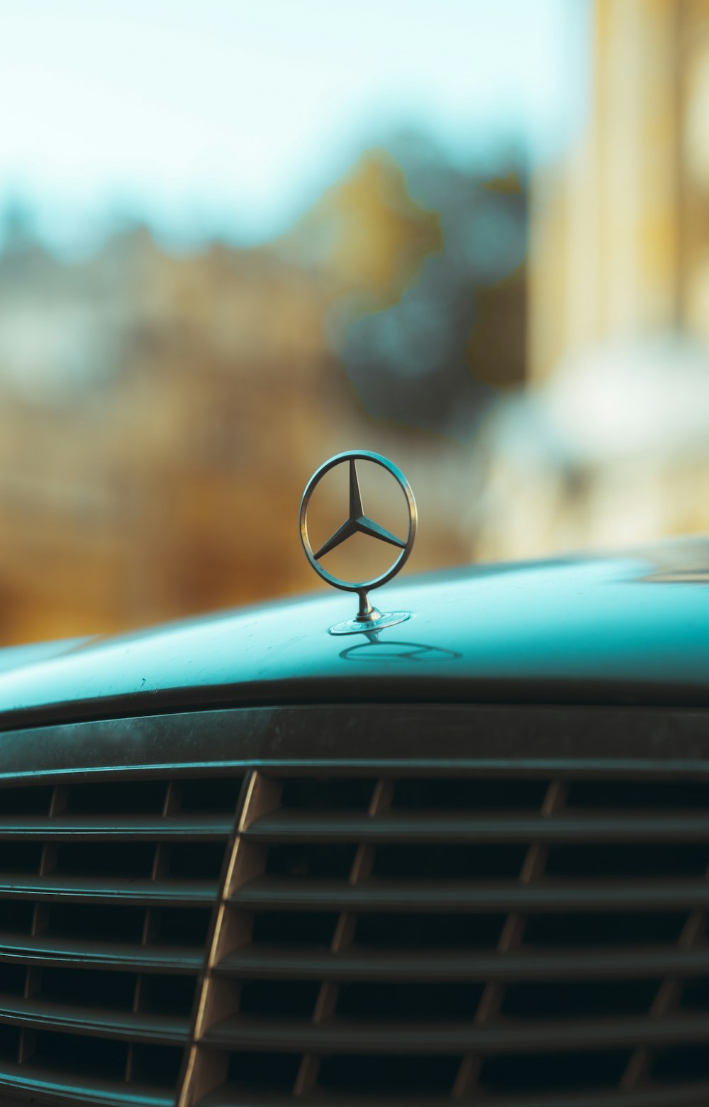 silver mercedes benz car with black and brown heart shaped emblem