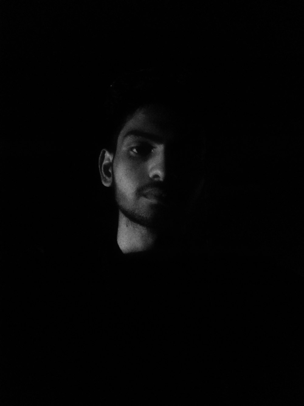 mans face in grayscale photography