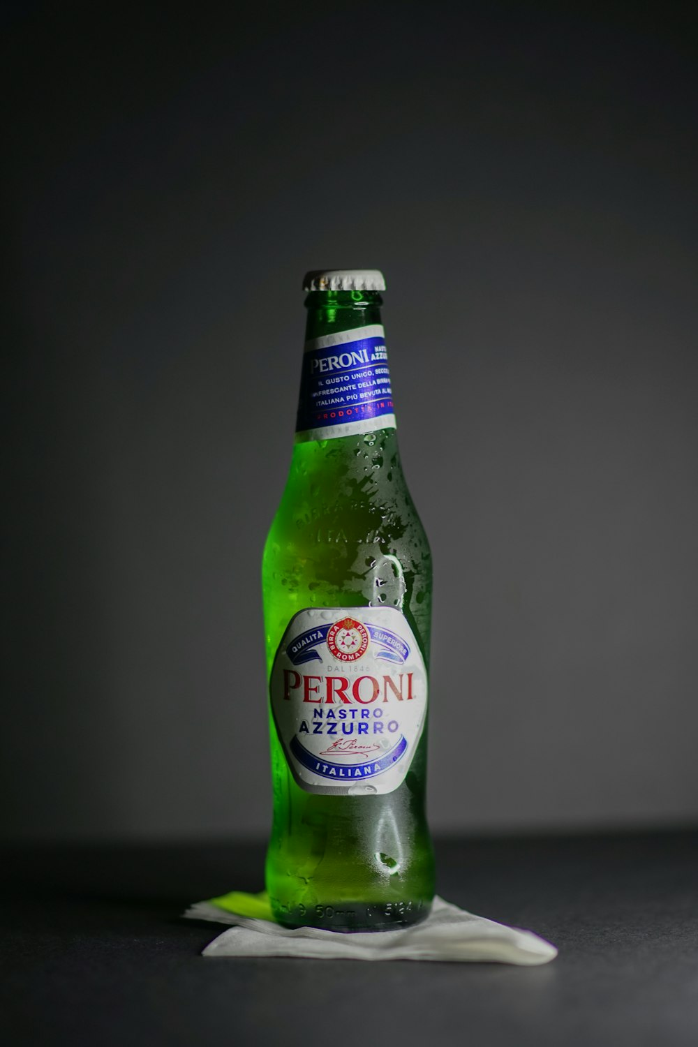 green glass bottle on white table