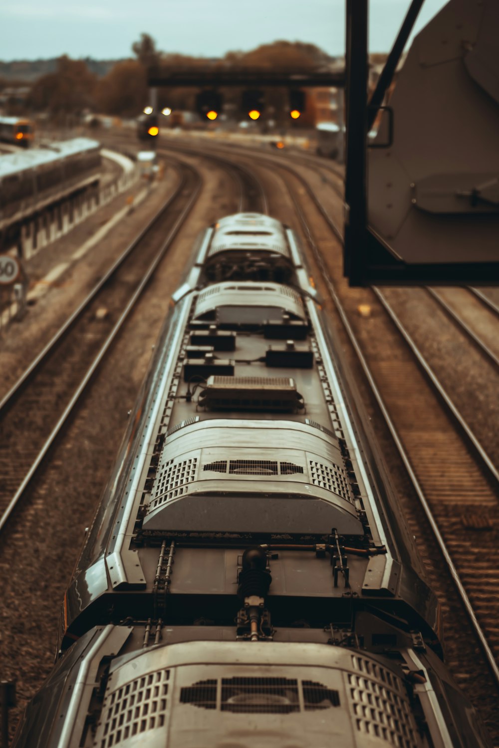 white train on rail way during daytime