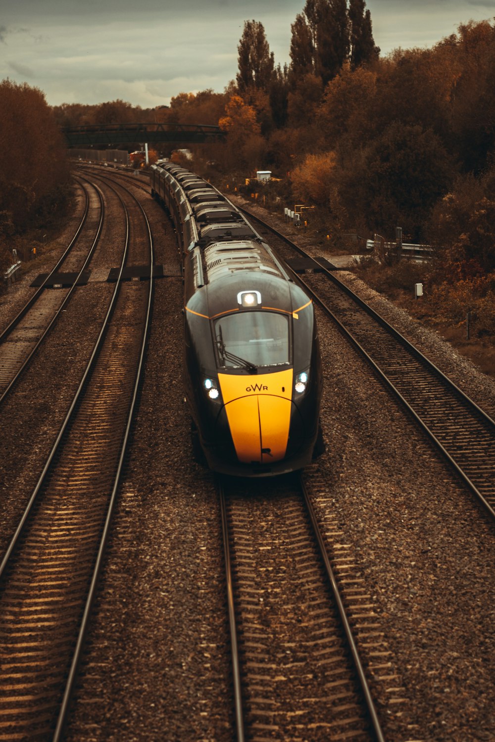 yellow and black train on rail tracks