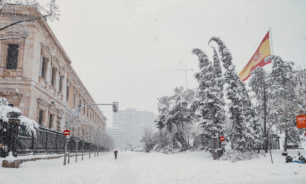 people walking on snow covered road near brown concrete building during daytime