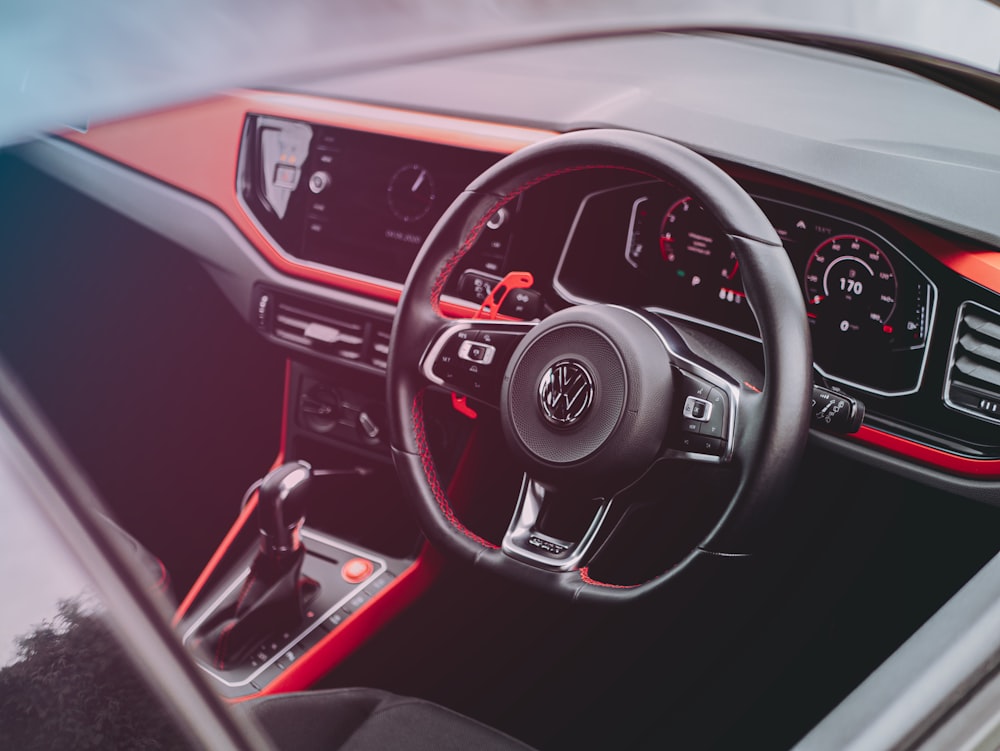 black and red car steering wheel