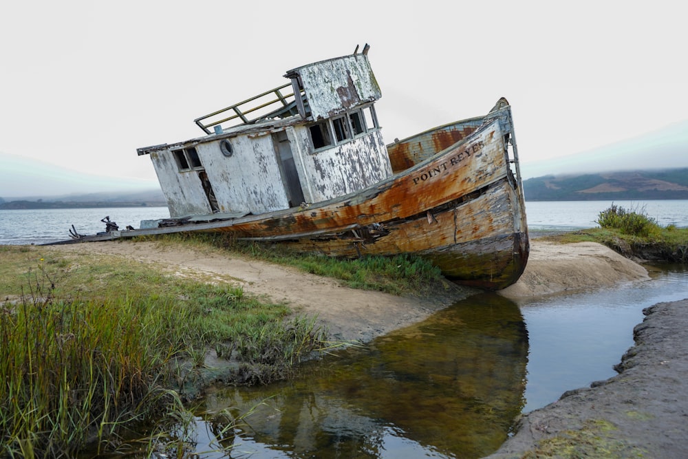 brown and white boat on river during daytime