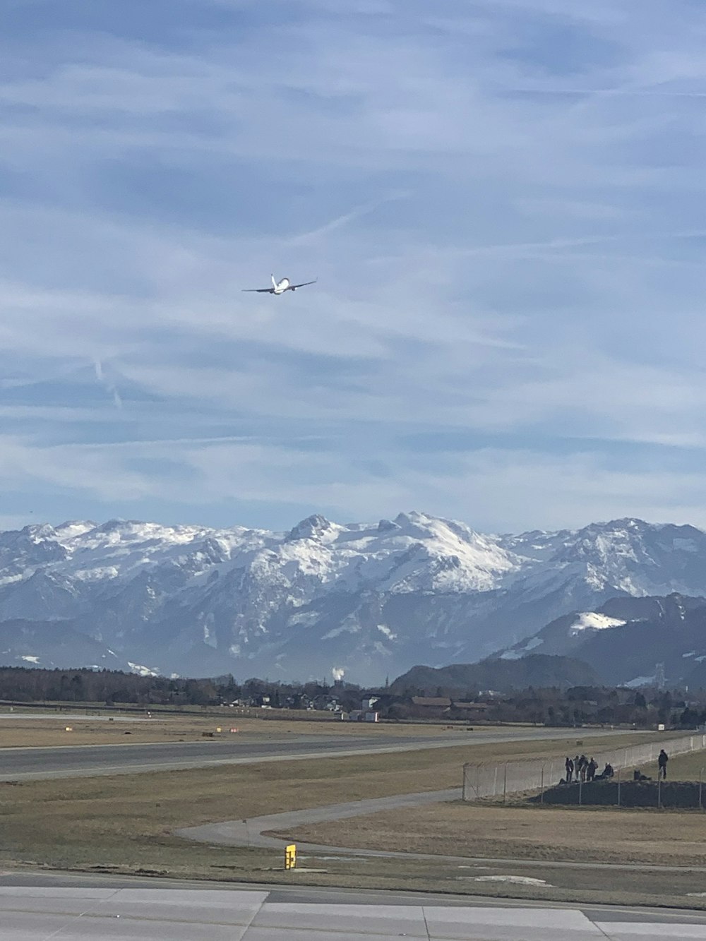 white and black airplane flying over the mountains during daytime